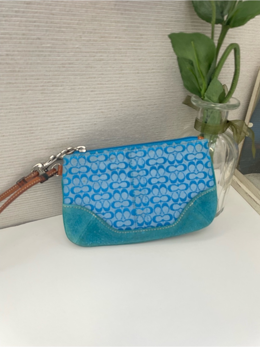 Coach Vintage Wristlet with Suede on the bottom.